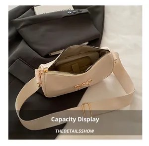 Interior view showing the large capacity of a cream shoulder bag with golden bow buckle