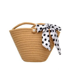 Fashionable woven straw handbag with polka dot silk ribbon and pearl closure for women