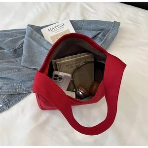 Interior view of red canvas tote bag showing storage capacity for books and daily items