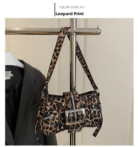 Detail of leopard print shoulder bag with silver studs and metal buckle hardware