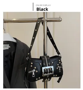 Detail of black punk motorcycle bag with silver studs and metal buckle straps