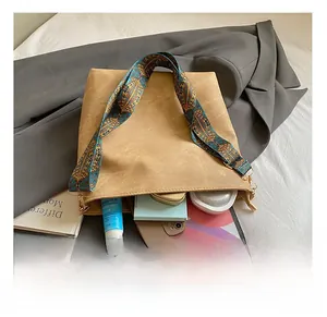 Interior view of brown suede tote bag showing capacity for tablet and daily essentials
