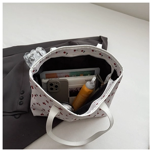 Top view of large white floral tote bag showing spacious interior with daily essentials