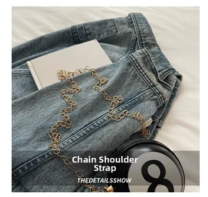 Close-up of number 8 creative ball-shaped mini bag with gold chain strap detail