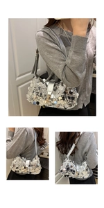 Close-up of shiny silver large sequin shoulder bag with adjustable strap and metallic buckle