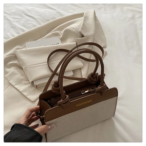 Detail of vintage tote bag with canvas and leather patchwork plus knot handle decoration