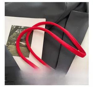 Detailed macro view of soft red suede material with a durable metal zipper and refined texture