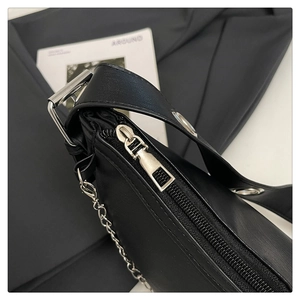 Macro detail of high-quality black leather texture with silver zipper and metal chain
