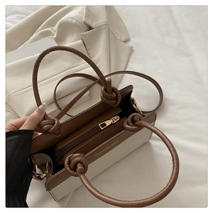 Detail of knot handle and FASHION BAG print on brown vintage canvas tote bag
