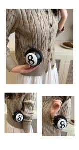 Detailed view of billiard black 8 ball mini purse with gold chain and glossy PU leather