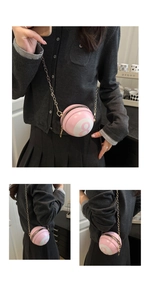Detail of pink billiard 8-ball spherical crossbody bag with golden chain strap