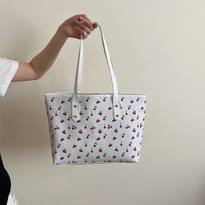 White tote bag with cherry print and golden studs for a cute 2025 autumn style