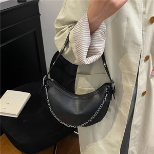 Chic black crescent chain bag in matte leather featuring silver hardware and adjustable strap