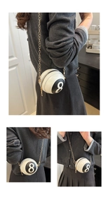 Detailed macro view of an 8-ball billiards design crossbody bag with gold chain strap