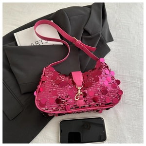 Flat lay of pink sequin shoulder bag with golden hook and chic fashion accessories