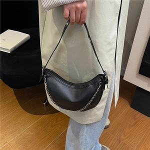 Fashionable black faux leather hobo bag with silver chain strap and metal grommet details