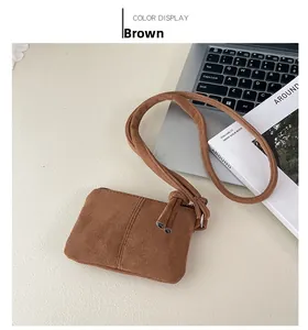Detail view of a vintage brown suede mini square bag with elegant parallel stitching