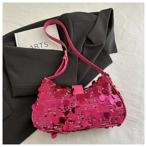 Detail of trendy magenta sequin shoulder bag with large metallic discs and leather strap