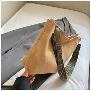 Close-up of khaki canvas tote bag with bohemian patterned wide shoulder strap