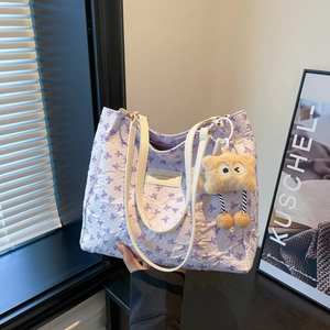 Sac fourre-tout lilas texturé avec imprimés nœuds violets et fines anses blanches