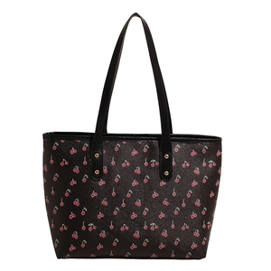 Chic black tote bag with red cherry floral print and gold stud details for daily commute