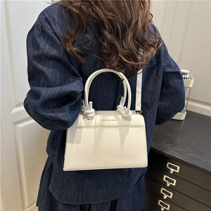 White vintage faux leather tote bag with top handle and adjustable shoulder strap