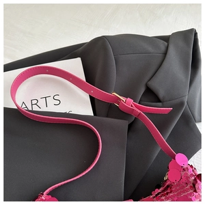 Close-up of rose pink sequin bag featuring adjustable faux leather strap and gold buckle