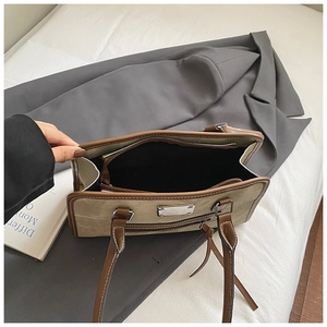 High-angle shot showing internal compartments and silver hardware of khaki tote bag