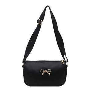 Minimalist black underarm bag with a gold bow accent and wide fabric shoulder strap