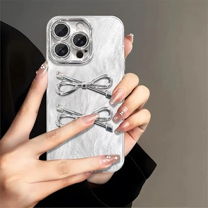 Elegant iPhone case with pearl texture, 3D silver bows, and metallic camera guard