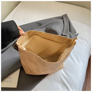 Detail of the khaki tote bag interior featuring a secure zipper pocket and spacious lining