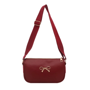Elegant wine red crossbody bag with golden metal bow detail and adjustable shoulder strap