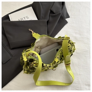 Internal view of neon sequin shoulder bag showing storage space for phone and makeup