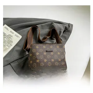 Detail view of contrast stitching bucket bag with star pattern and wide fabric strap