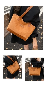 Outdoor street view of caramel suede tote bag with contrast faux leather panels and logo