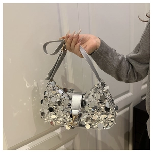 Detailed view of silver sequin shoulder bag featuring large mirror paillettes and strap