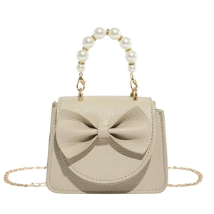 Chic cream mini handbag featuring a decorative bow and luxurious faux pearl handle