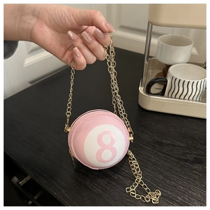 Detail of creative pink billiard 8-ball crossbody bag with elegant gold chain strap