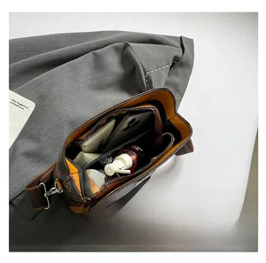 Top view of classic patterned crossbody bag interior showing compartments and yellow lining