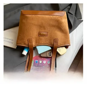 Interior view of large brown suede patchwork tote bag showing spacious storage for tablet
