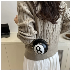 Detail of creative number 8 billiard ball shaped crossbody bag with gold chain strap