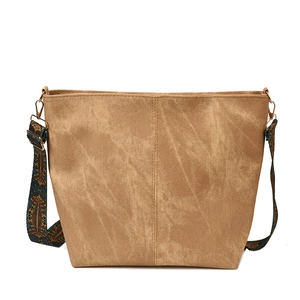 Classic khaki canvas tote bag with a vintage patterned wide shoulder strap on white backdrop