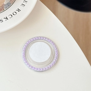 Detail of a round magnetic phone grip featuring light purple iridescent pearls on a white base