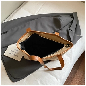 Top view of large canvas tote bag showing spacious black interior and zipper detail