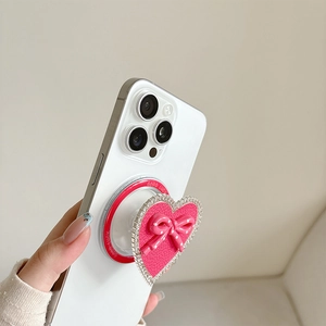 Pink heart-shaped rhinestone phone socket with a dotted bow and Good Luck text