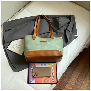 Large bean green canvas tote bag with brown leather contrast and spacious interior