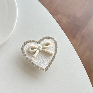 Detail of heart phone socket featuring rhinestone trim and pink polka dot bow decoration