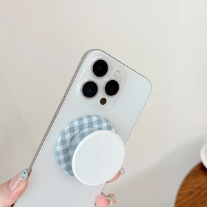 Gingham pattern magnetic cell phone pop socket stand on a white smartphone