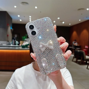 Detailed view of luxury rhinestone bow phone case for iPhone with silver metal strap rings