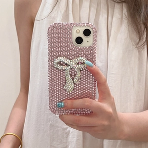 Luxurious pink rhinestone iPhone case featuring a large shimmering 3D crystal bow design
